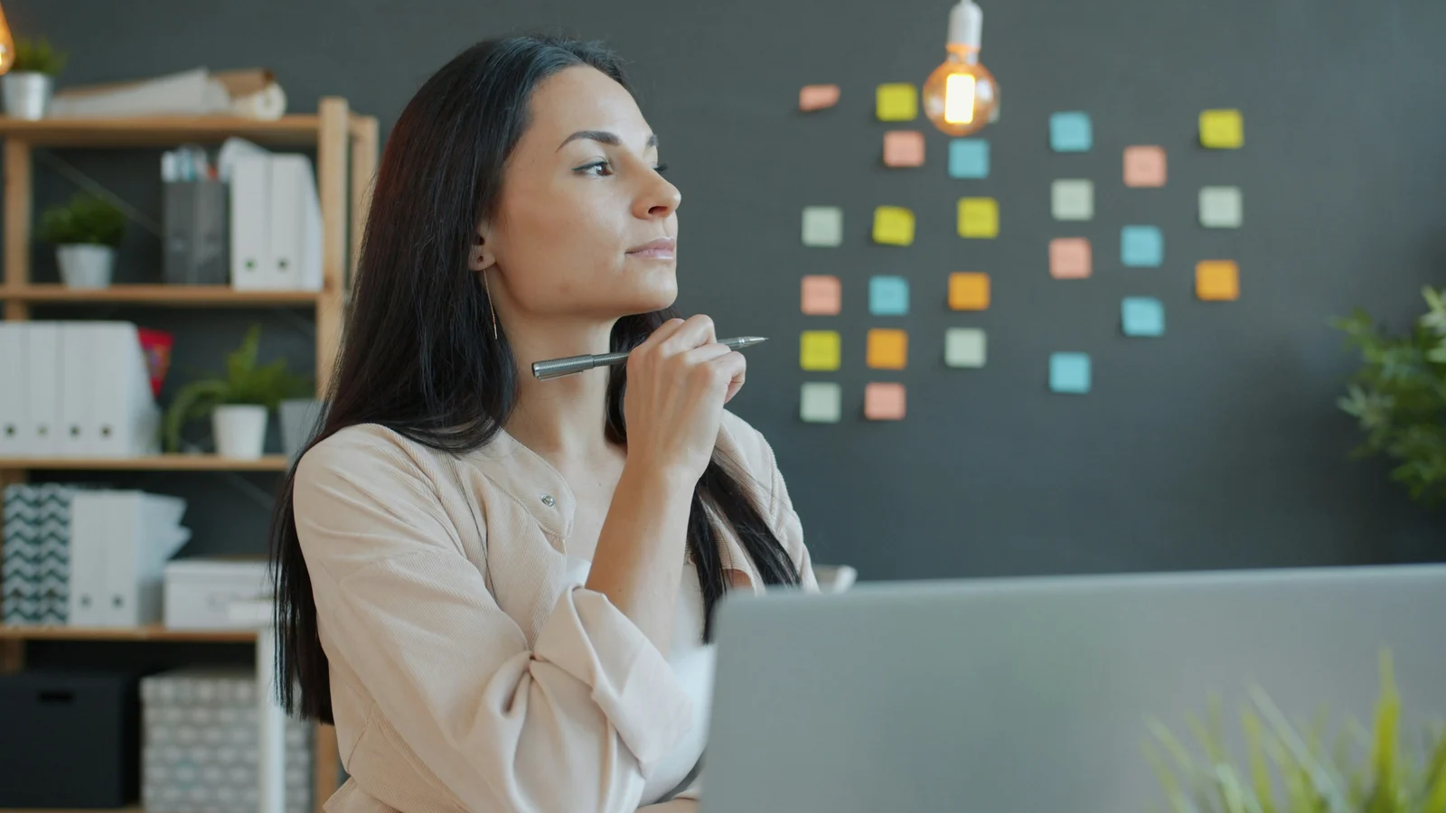 A professional weighing a decision at her desk